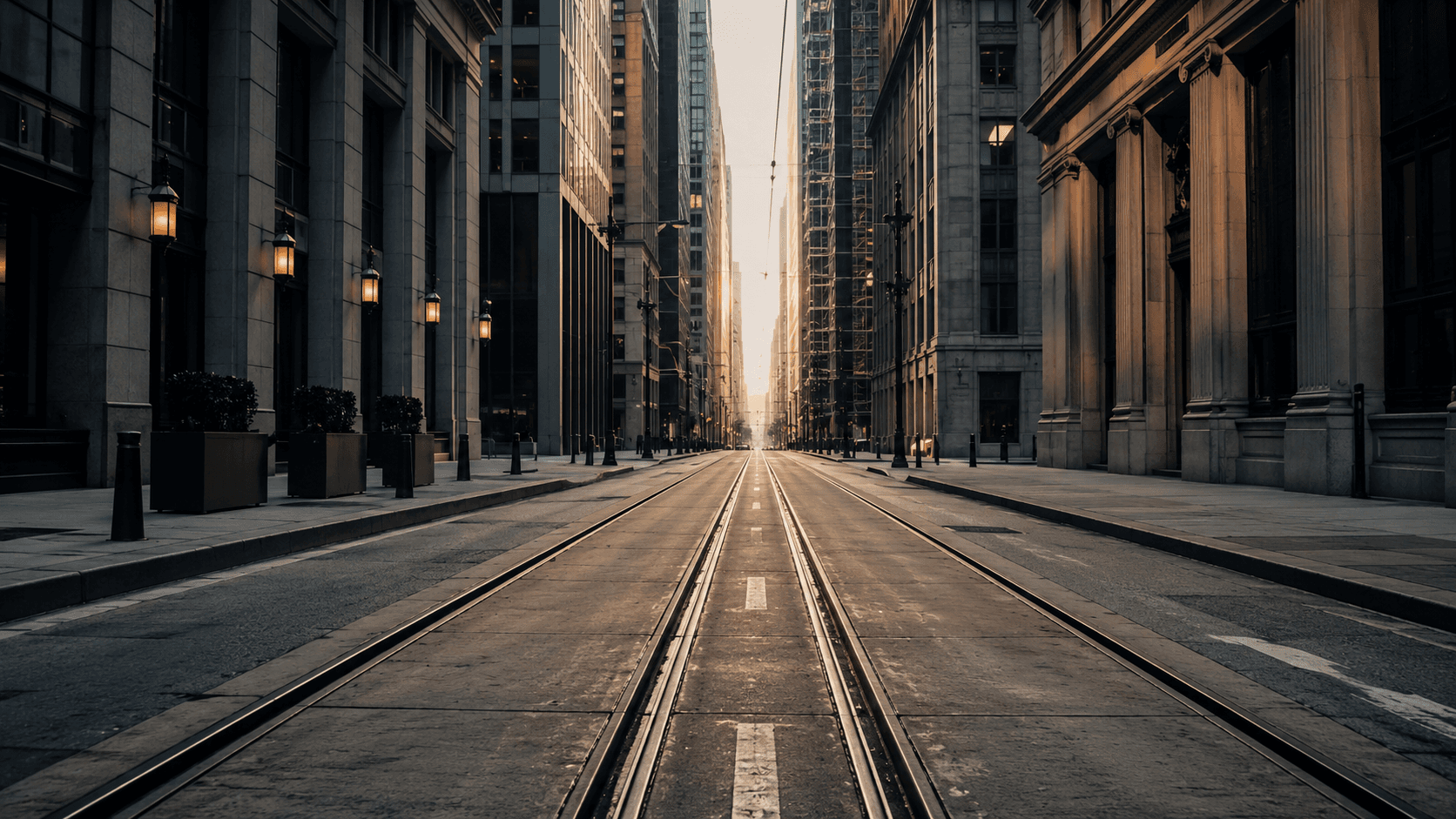 A dense downtown Norfolk street with light rail tracks running between tall buildings
